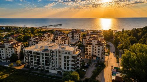 an aerial view of a city with the ocean at Boutique 1BR | Long Beach Sea View Next to the Beach in Shkorpilovtsi