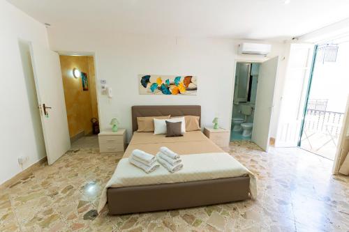 a bedroom with a bed with two towels on it at Casa Antonella in Trabia