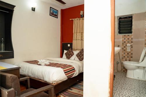 a bedroom with a bed and a bathroom at Admire Hotel Pvt Ltd in Pokhara