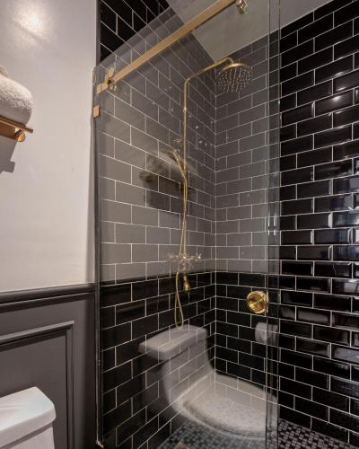 a bathroom with a glass shower with a tub at The Green Escape Suite in Mexico City