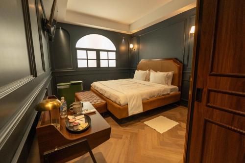 a small bedroom with a bed and a table at The Green Escape Suite in Mexico City