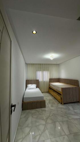 a bedroom with two beds in a room at Vue Mer in Hammamet Nord