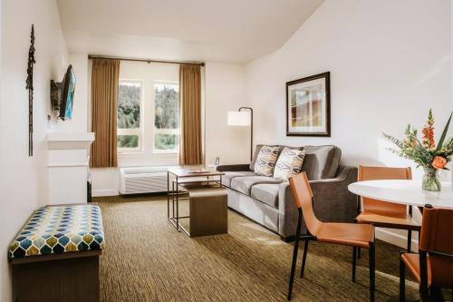 a living room with a couch and a table at Executive Suites Hotel and Resort, Squamish in Squamish