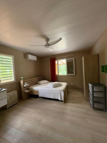a bedroom with a bed and a ceiling at Évasion Caraïbes in Ducos