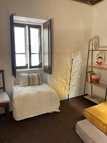 a living room with a bean bag chair and a window at Memórias in Nogueira da Regedoura