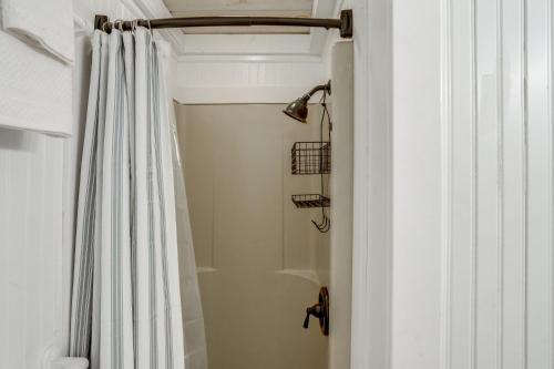 a bathroom with a shower with a shower curtain at High-Design Monroe Cabin on 2 Private Acres! in Readsboro