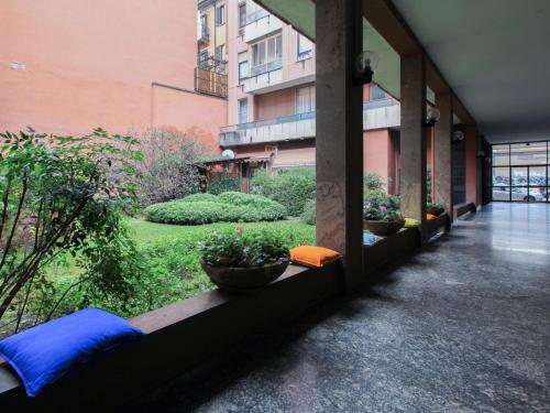 
a patio area with a balcony and a window at Aramis House Citycentre - con parcheggio Gratis - with Free parking - zona Navigli -Bocconi in Milan
