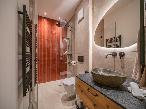 a bathroom with a sink and a toilet at Premium Apartment Almrausch in Hollersbach im Pinzgau