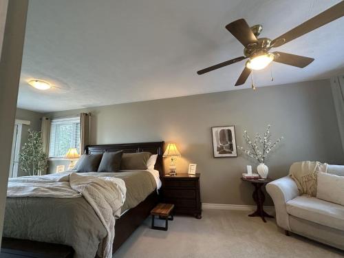 a bedroom with a bed and a ceiling fan at Waterfront 22' Windows Starlink Kayaks in Tobermory
