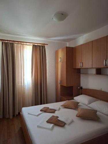 a bedroom with a large bed with towels on it at Apartments with parking space Igrane, Makarska - 13535 in Igrane
