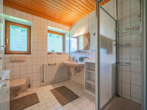a bathroom with a shower and a toilet and a sink at Getzfeld-Hof in Westendorf