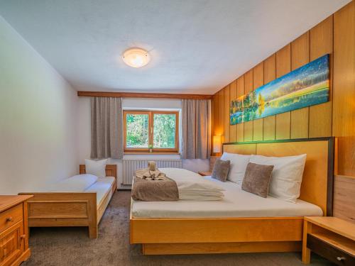 a hotel room with two beds and a desk at Getzfeld-Hof in Westendorf