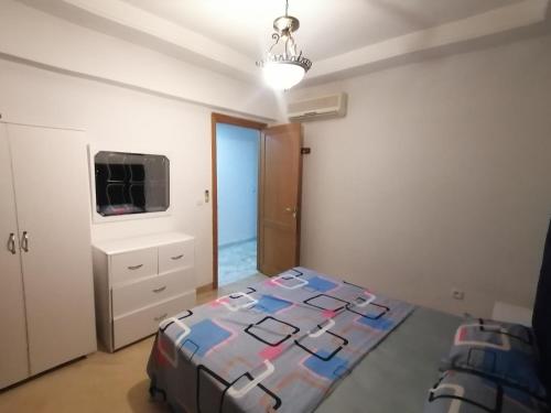 a bedroom with a bed and a television in it at Appartement S3 Haut Standing 141m2 Connecté avec Fibre - 7-10 min Aéroport in Burj at Turkī