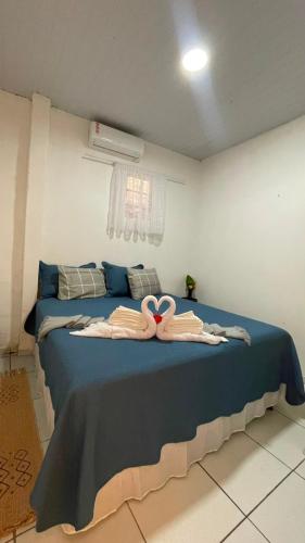 a bedroom with a bed with two towels on it at Ksa Sodré in Barreirinhas