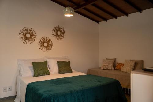a bedroom with a bed and two mirrors on the wall at Pousada Estação Cajueiro in São Miguel do Gostoso