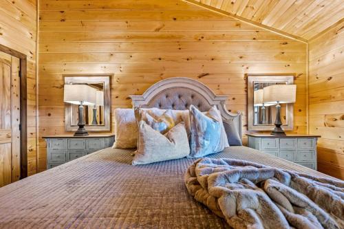 a bedroom with a large bed with two lamps at Top Rated Modern 3BD |Secluded |Fire Pit |Arcade in Sevierville