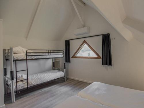 a bedroom with two bunk beds and a window at Lac Bleu 40 in Lacapelle-Marival