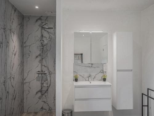 a white bathroom with a sink and a shower at Lac Bleu 40 in Lacapelle-Marival