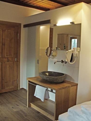 a bathroom with a sink and a mirror at Mammhofer Suite & Breakfast in Oberammergau