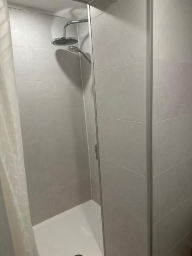 a shower with a glass door in a bathroom at Bedroom with extension on Veranda in Yvoir