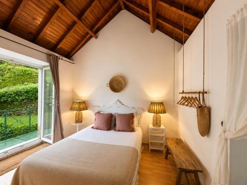 a bedroom with a bed and a window at Sintra Center Guest House Escape to Nature in Sintra