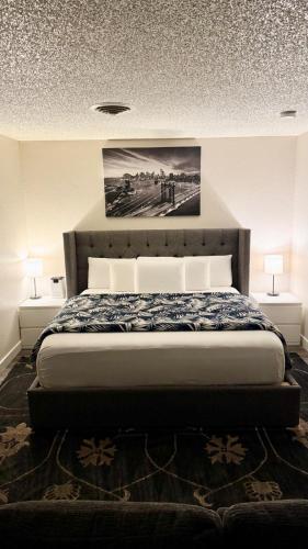 a bedroom with a large bed with two lamps at Prime Lux Modern & Cozy Studio in Salt Lake City