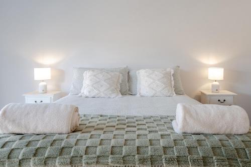 a bedroom with a large bed with two lamps at Kookora Suites in Griffith