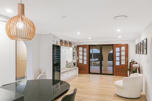a kitchen and dining room with a glass table at Salthill in Tweed Heads
