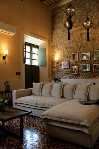 a living room with a couch and a table at Casa Chultun Mérida Centro in Mérida