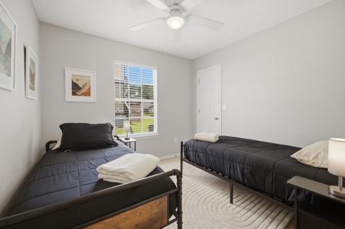 a bedroom with two beds and a ceiling fan at Bed n Bikefast in Bentonville