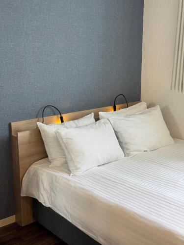 a bedroom with a bed with white pillows at Megu Fuji 2021 in Fujiyoshida