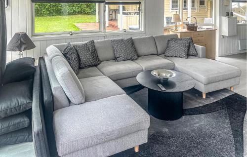 a living room with a couch and a table at 4 Bedroom Cozy Home In Stege in Stege