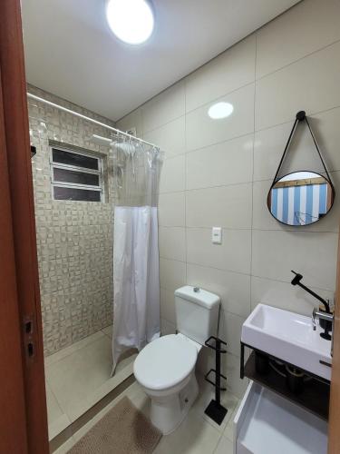 a bathroom with a toilet and a shower and a sink at Casa Brisa - Las Caracolas in Rio Grande