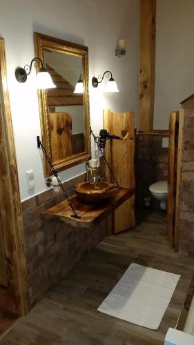 a bathroom with a wooden sink and a mirror at Zimmer im Lungau in Sankt Michael im Lungau
