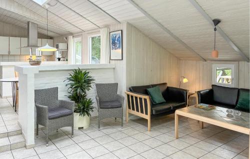 a living room with a couch and chairs and a table at Holiday Home Blåbærvangen V in Oxbøl
