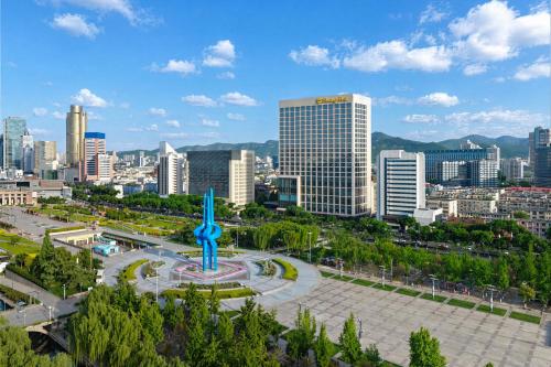 a city with a statue in the middle of a park at Shangri-La Jinan in Jinan