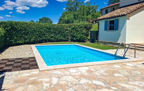 a swimming pool in a yard next to a house at Lukas-Gologorica in Gologorica