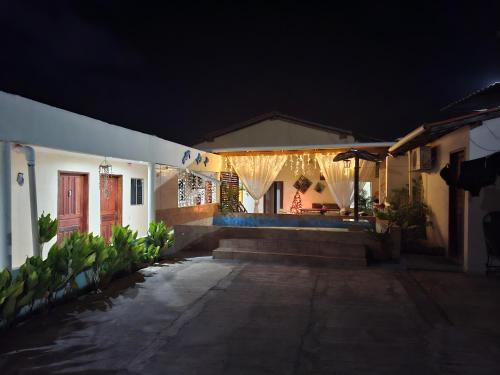 a house with a porch at night with lights at Anthony in Salinópolis