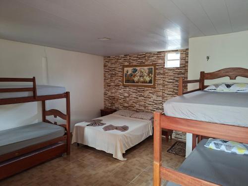 a bedroom with two bunk beds and a baby crib at Anthony in Salinópolis