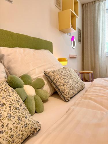 a bed with two pillows and a stuffed animal on it at Sitka1 apartment in Trenčín