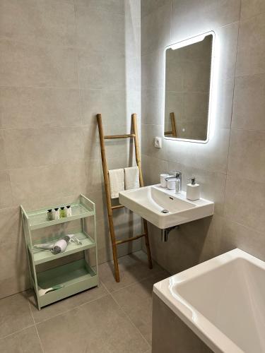 a bathroom with a sink and a mirror at Sitka1 apartment in Trenčín
