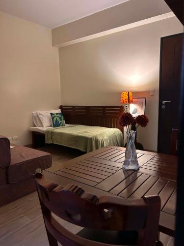 a living room with a table and a bed at Sweet Escape Executive Studio at One Regis in Bacolod