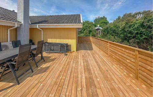 a wooden deck with a grill on a house at Holiday Home Laxtonvej Humble in Humble