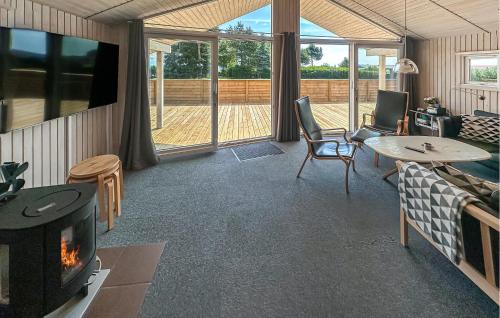 a living room with a couch and a fireplace at Holiday Home Laxtonvej Humble in Humble