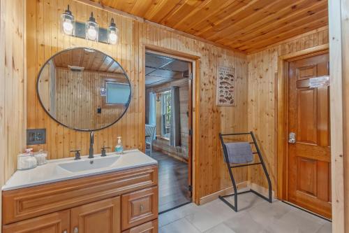 a bathroom with a sink and a mirror at Riverside Cabin with Private Fishing Access! in Pulaski