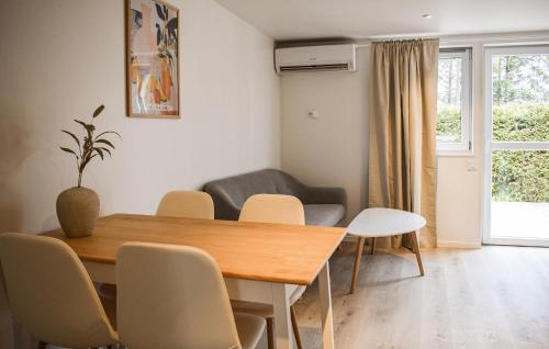 a dining room with a table and chairs and a couch at Beautiful Home In Ystad in Ystad