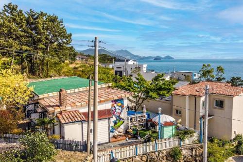 an overhead view of a house with a green roof at Namhae arahil pension in Namhae