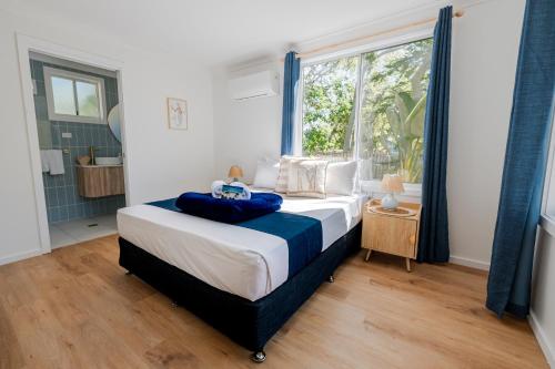 a bedroom with a large bed and a window at Great Keppel Island Hideaway in Great Keppel