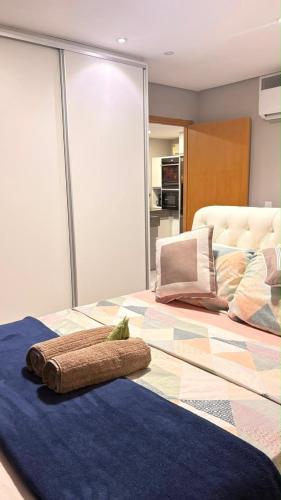 a bed with a towel on top of it at Flat Paiva Bugam - Paiva Home Stay in Recife