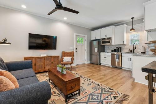 a kitchen and living room with a couch and a table at Loft Haven - Rooftop Terrace in Charlotte